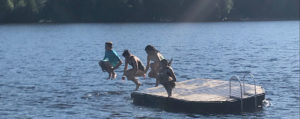 Kids jumping off dock into water