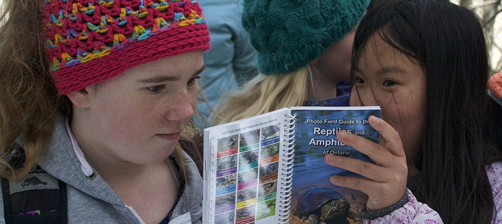 Two girls discover, Identify and reporting species at a Sydenham River Nature Reserve event