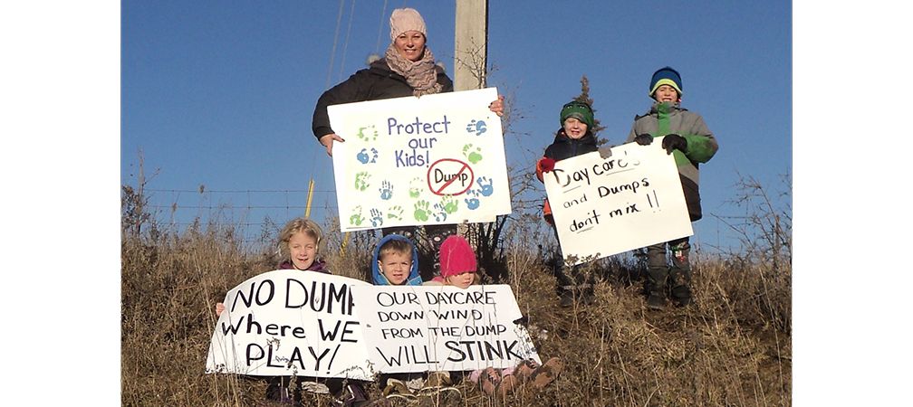 Beachville Daycare nearby mega garbage dump, kids with protest signs