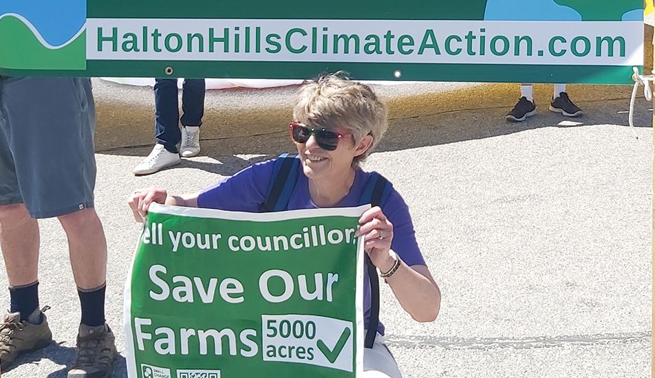 Jane Fogal with save our farms sign