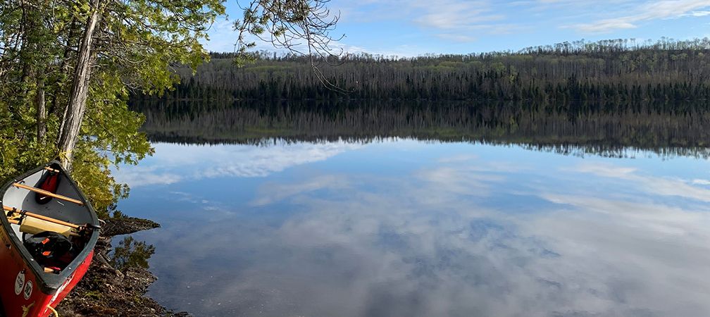 Canoe and morning reflections on Moonshine Lake, Wabakimi Provincial Park